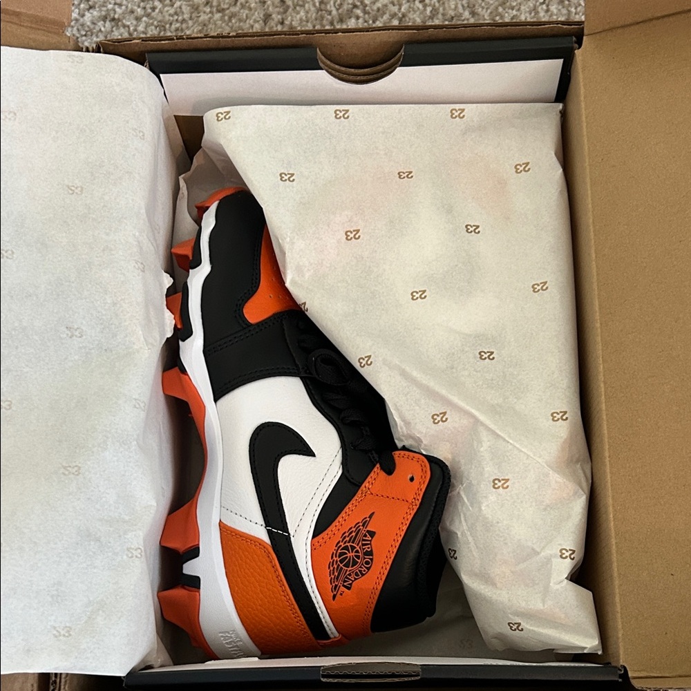 Nike Air Jordan Black, Orange, and White Football Cleats